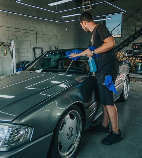 a-man-waxing-a-car-in-a-garage